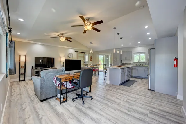 a living room with furniture and a wooden floor