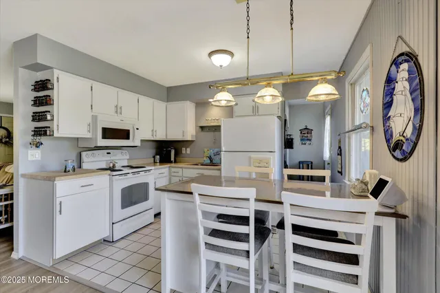 a kitchen with cabinets and stainless steel appliances