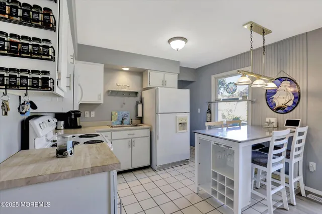 a kitchen with granite countertop a sink appliances a counter top space and cabinets