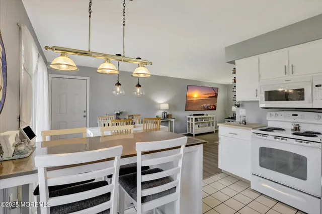 a kitchen with a stove a sink and a refrigerator
