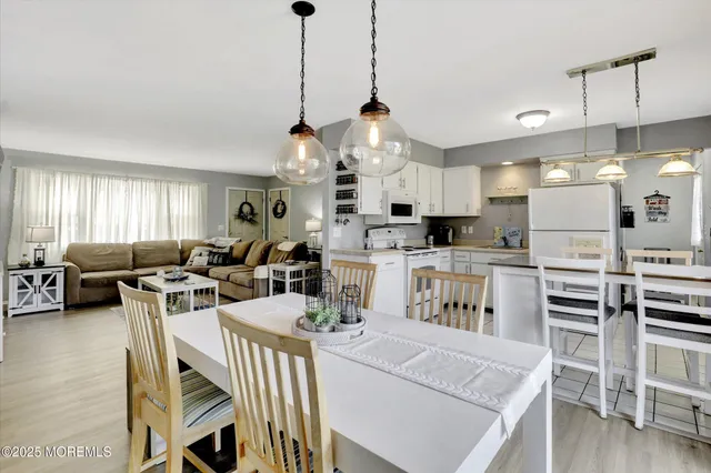 a living room with lots of furniture and kitchen view