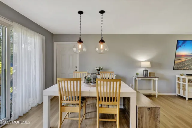 a view of a dining room with furniture wooden floor and chandelier