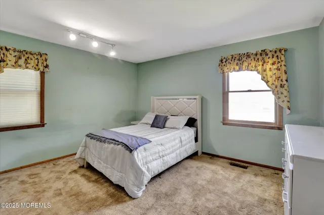 a bed room with a bed and a window