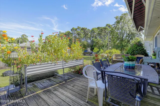 a view of a balcony with chairs and wooden floor