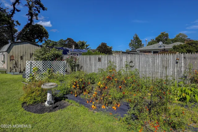 a view of backyard with swimming pool and outdoor seating