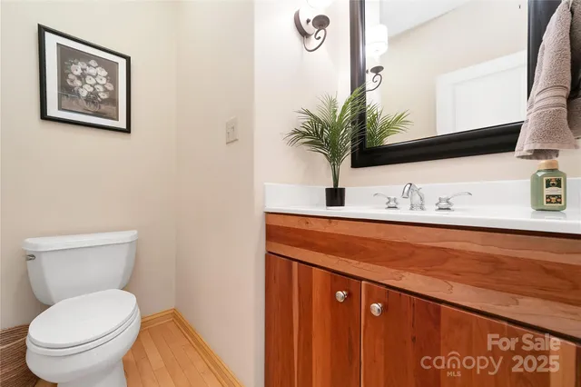 a bathroom with a toilet a sink and mirror