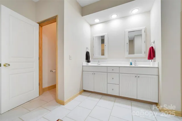 a spacious bathroom with a mirror sink and vanity