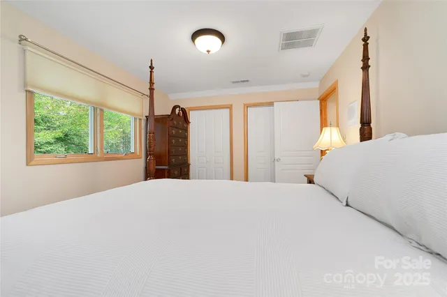 a bedroom with a large bed and a window