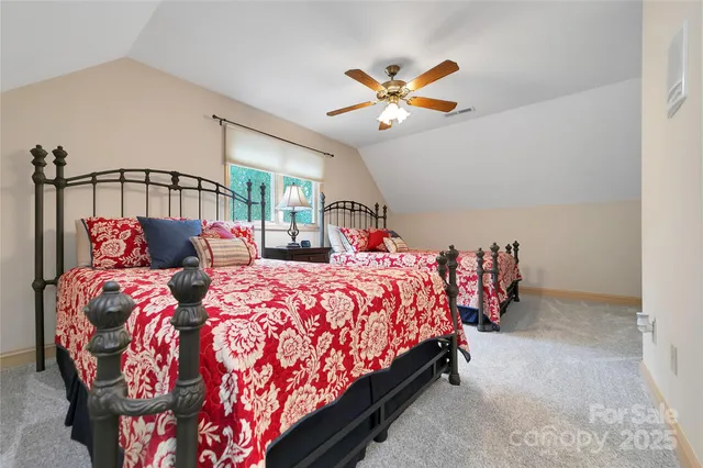 a bed sitting in a bedroom next to a window