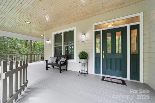 a view of a balcony with couch and wooden floor