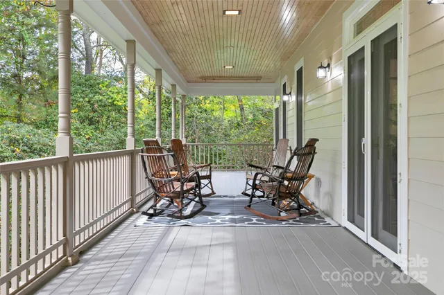 a view of balcony with chairs and wooden floor