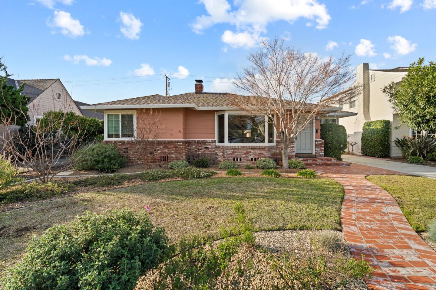 a front view of a house with garden