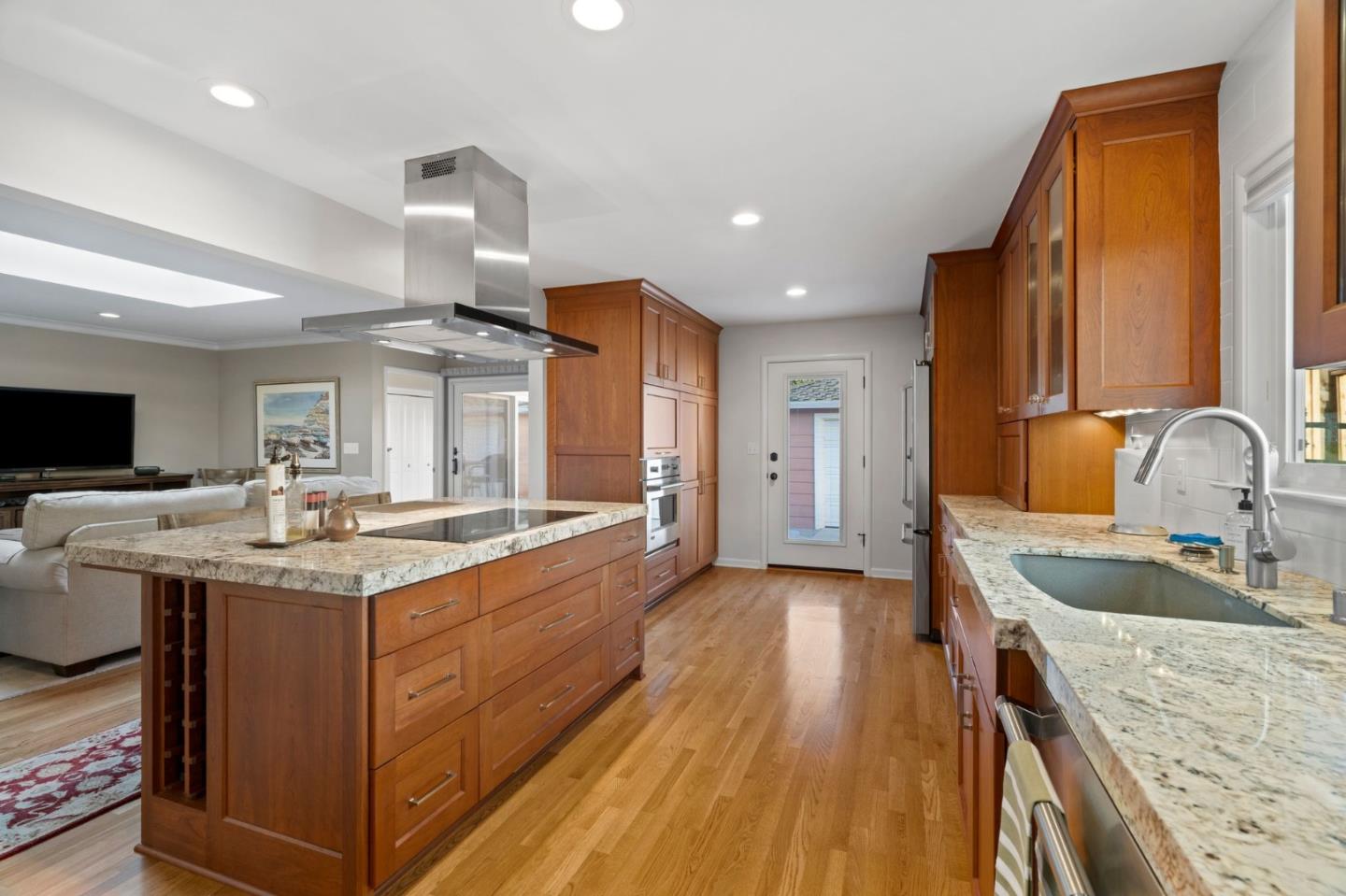 1765 Emory Street San Jose, CA 95126 - Photo 19 of 46 a kitchen with stainless steel appliances granite countertop a sink stove and wooden cabinets