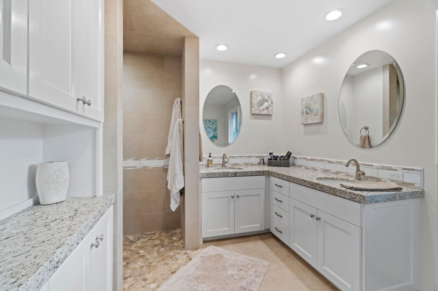 1765 Emory Street San Jose, CA 95126 - Photo 32 of 46 a spacious bathroom with a granite countertop sink and a mirror