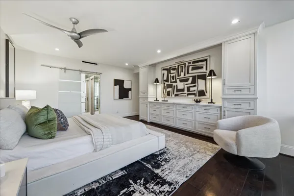 a bedroom with a large bed and a lamp