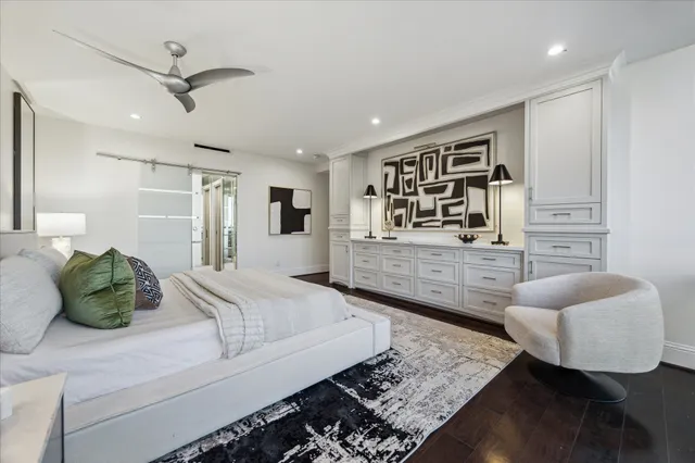 a bedroom with a large bed and a lamp