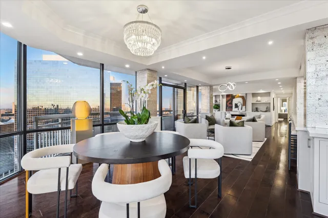a living room with lots of furniture and kitchen view
