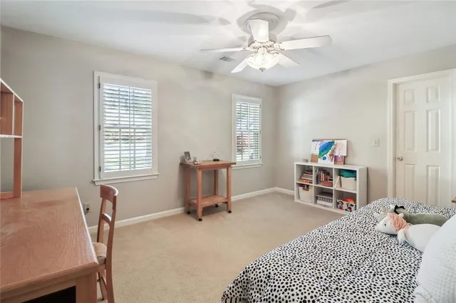 a bedroom with a bed a desk and chair