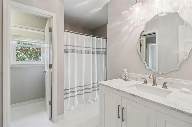 a bathroom with a double vanity sink and a mirror