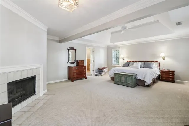 a spacious bedroom with a bed and a fireplace