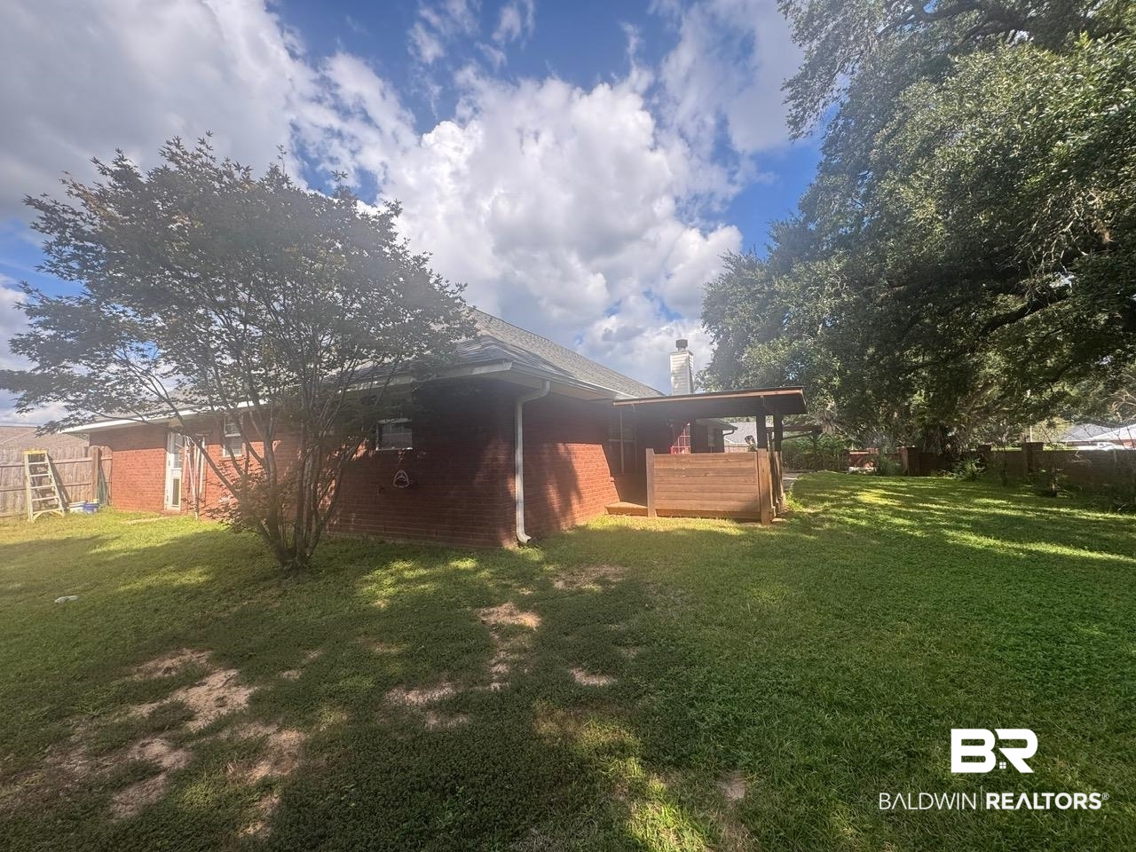 101 Monteith Circle Foley, AL 36535 - Photo 23 of 28 Rear view of house with a chimney and brick siding