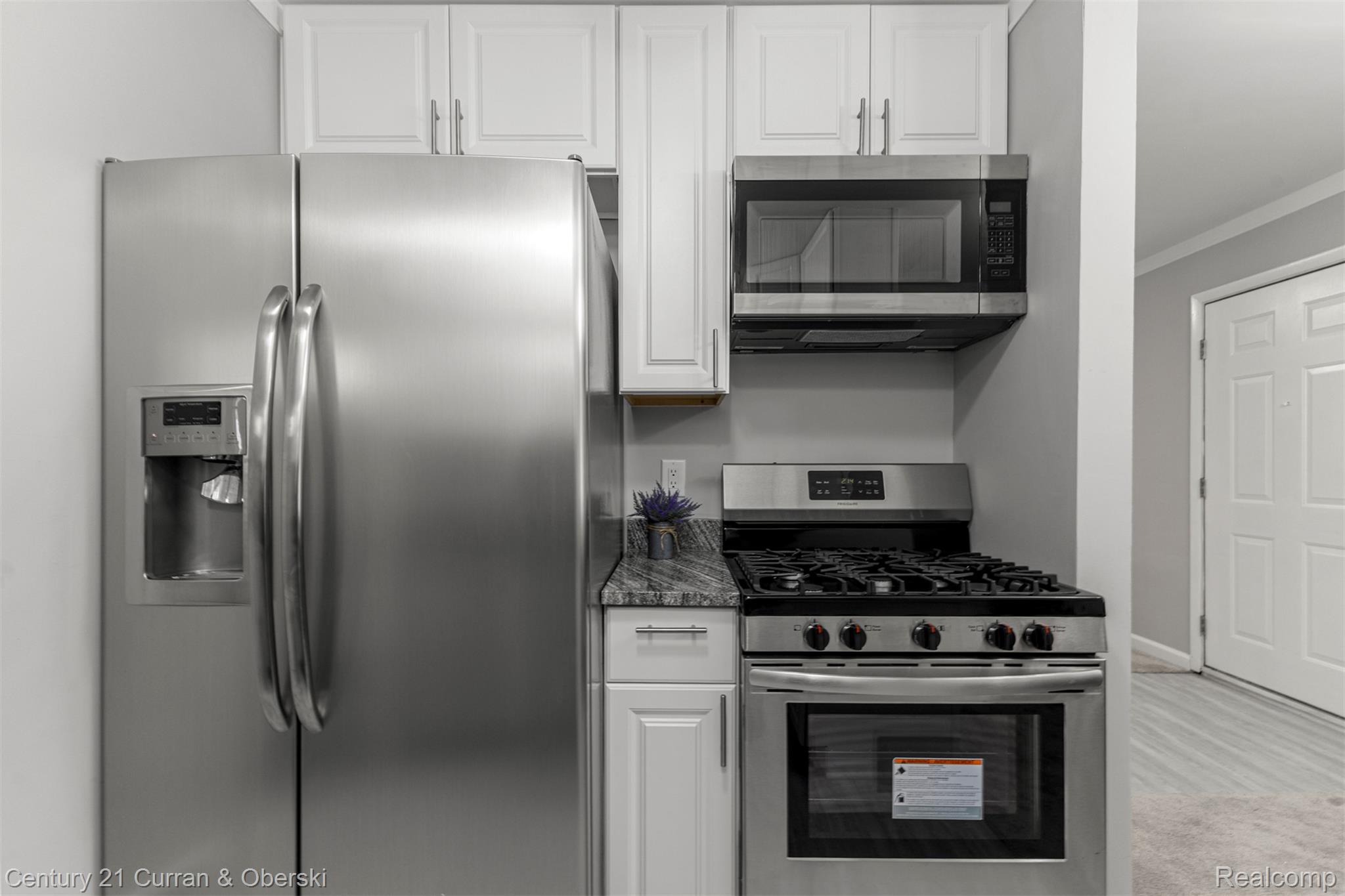 7120 Jackson Street Taylor, MI 48180 - Photo 18 of 24 Kitchen featuring stainless steel appliances, ornamental molding, white cabinetry, and dark stone countertops