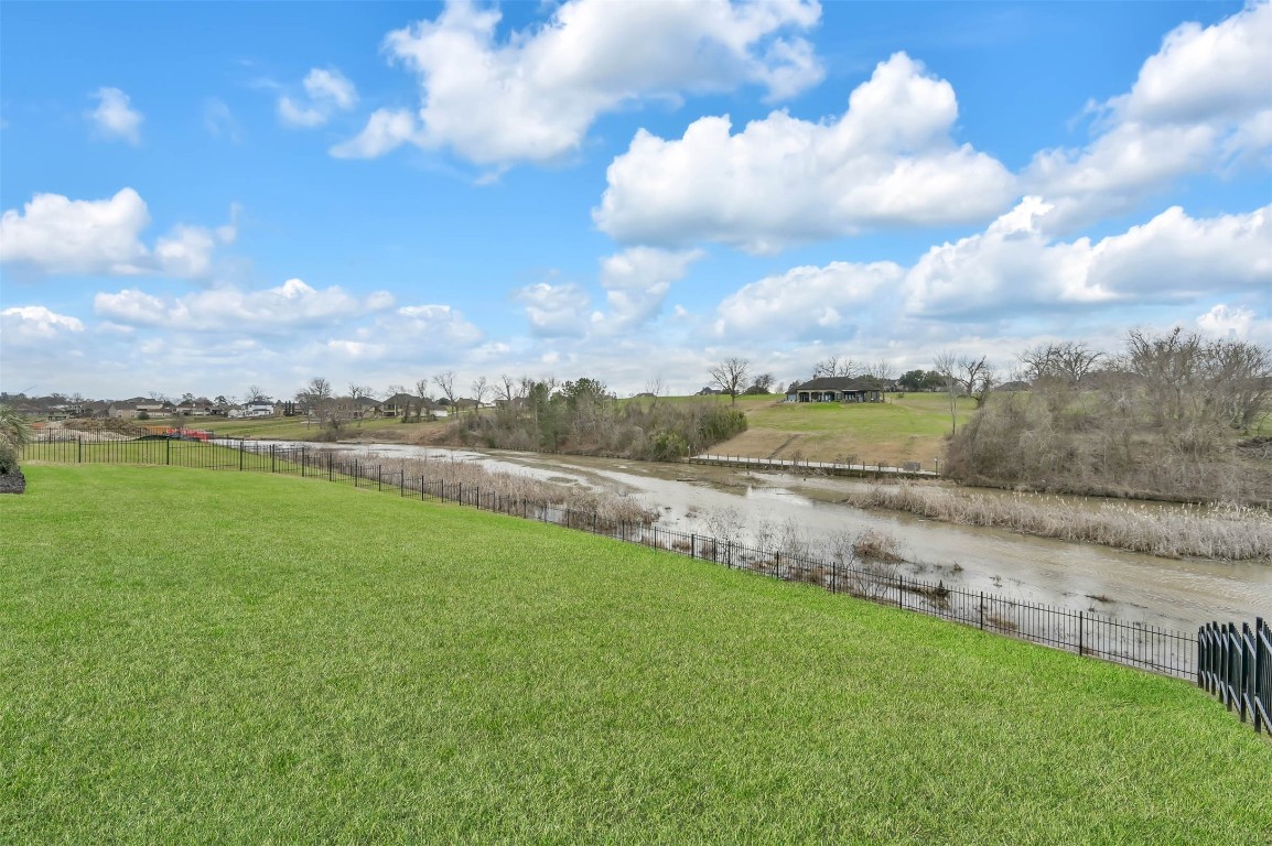11679 Renaissance Drive Montgomery, TX 77356 - Photo 2 of 2 a view of a lake with houses in the back