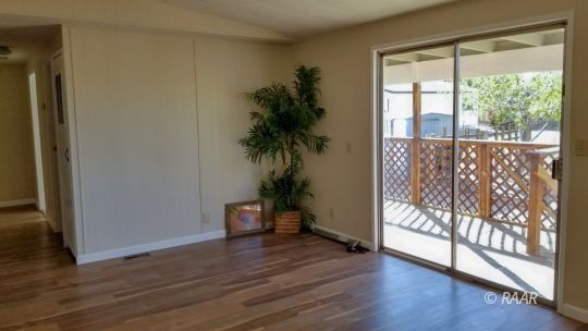 1441 West Perch Avenue Ridgecrest, CA 93555 - Photo 12 of 25 a view of empty room with wooden floor and fan