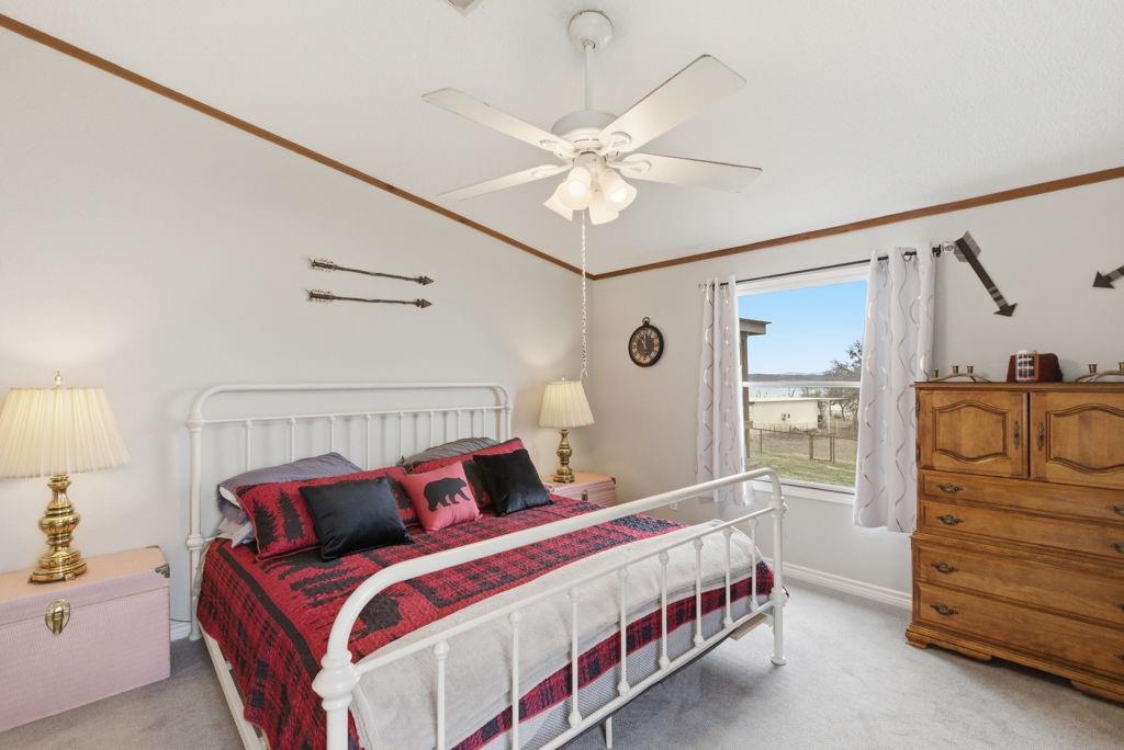 1919 Eastside Lake Road Graham, TX 76450 - Photo 11 of 24 a bedroom with a bed and cabinet