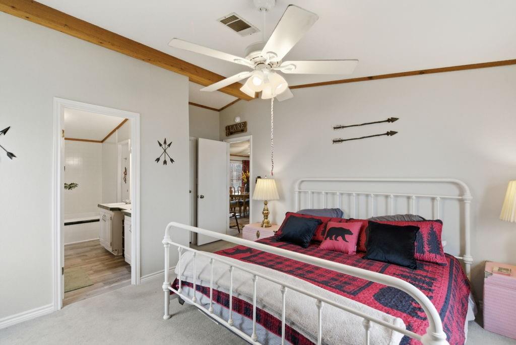 1919 Eastside Lake Road Graham, TX 76450 - Photo 12 of 24 a bedroom with a bed and a chandelier