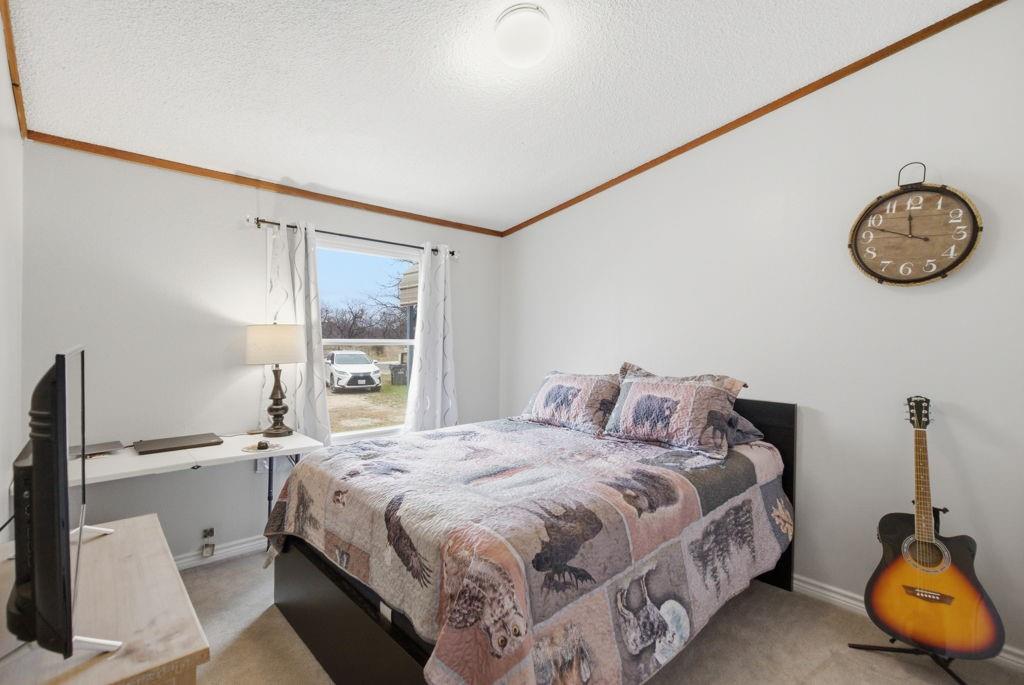 1919 Eastside Lake Road Graham, TX 76450 - Photo 14 of 24 a bedroom with a bed and a window