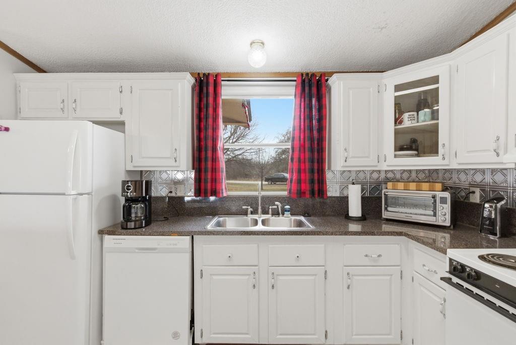 1919 Eastside Lake Road Graham, TX 76450 - Photo 9 of 24 a kitchen with a refrigerator and a sink