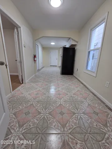 a view of a big room with closet and windows