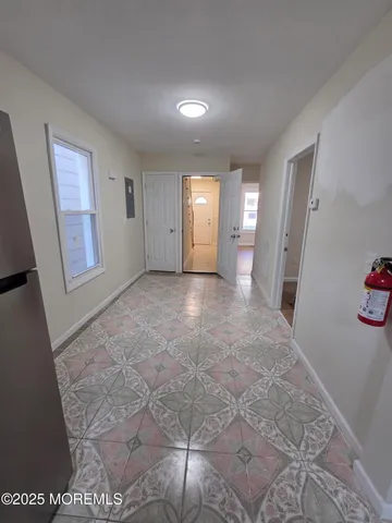 a view of a hallway with entryway door