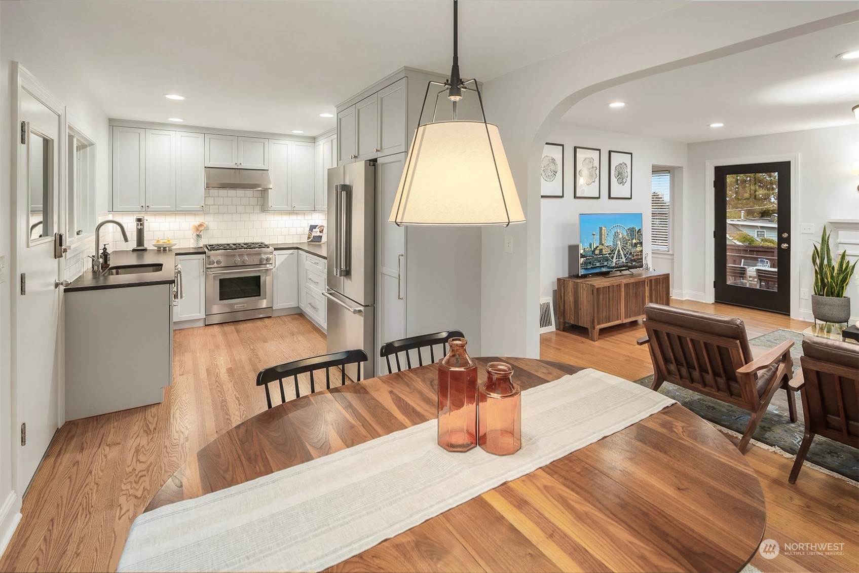 20 Armour Street Seattle, WA 98109 - Photo 11 of 34 a kitchen with stainless steel appliances granite countertop a sink dining table and chairs
