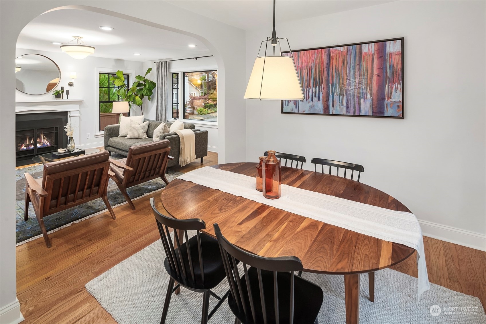 20 Armour Street Seattle, WA 98109 - Photo 12 of 34 a dining room with furniture a fireplace and wooden floor