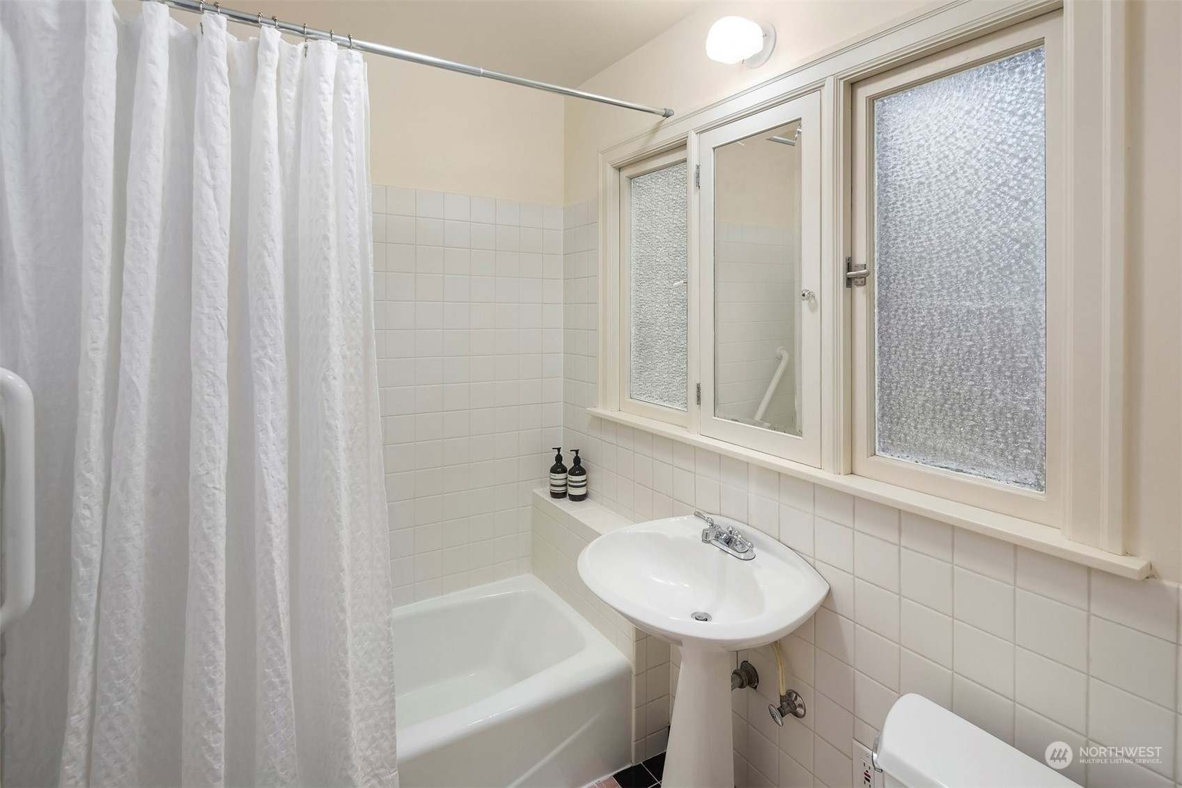 20 Armour Street Seattle, WA 98109 - Photo 13 of 34 a bathroom with a sink a toilet and shower