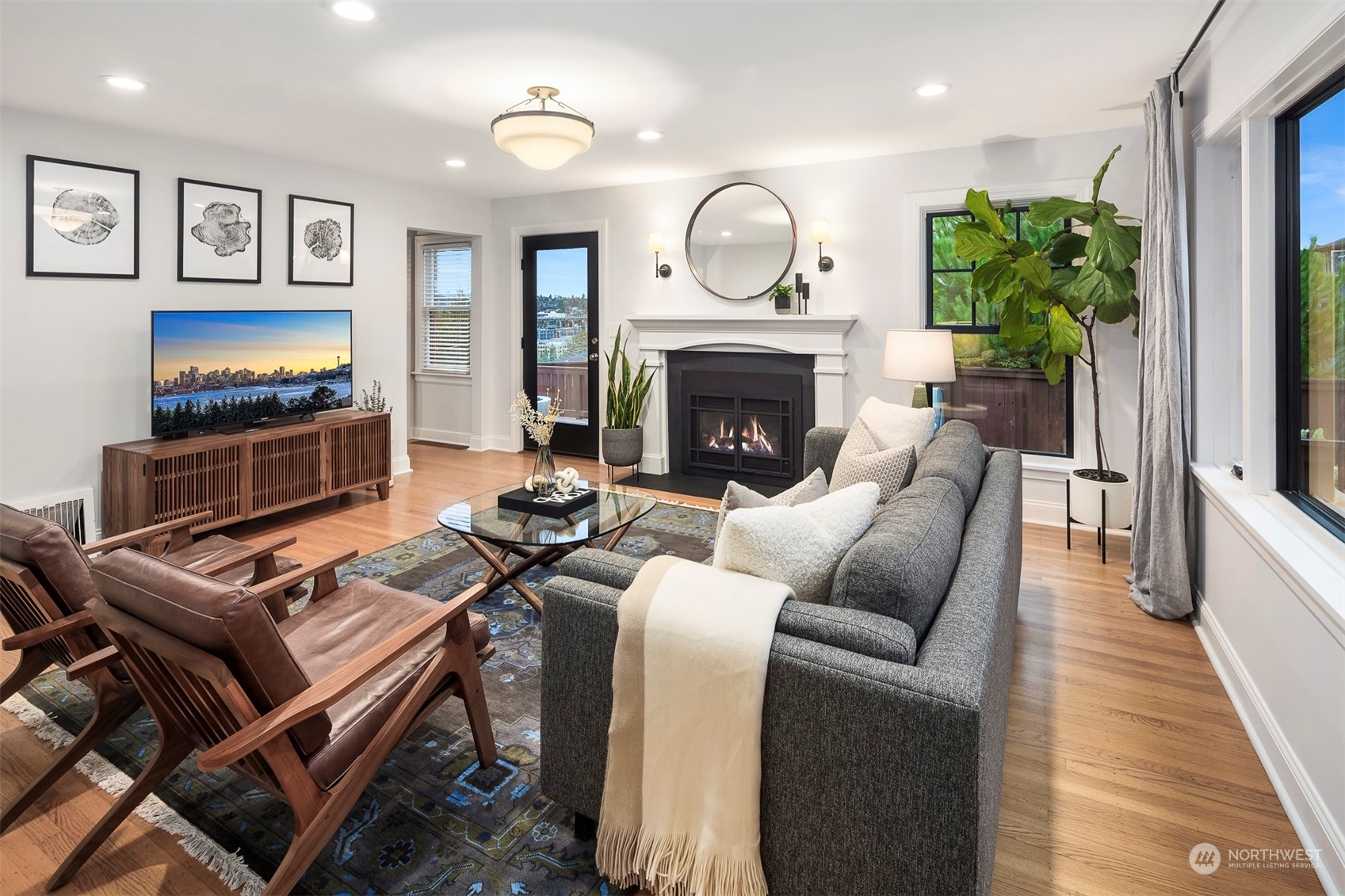 20 Armour Street Seattle, WA 98109 - Photo 5 of 34 a living room with furniture a flat screen tv and a fireplace