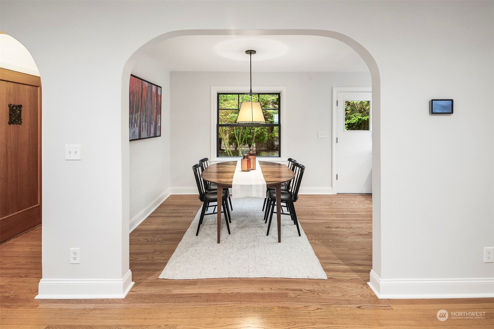 20 Armour Street Seattle, WA 98109 - Photo 7 of 34 a dining room with furniture a rug and wooden floor