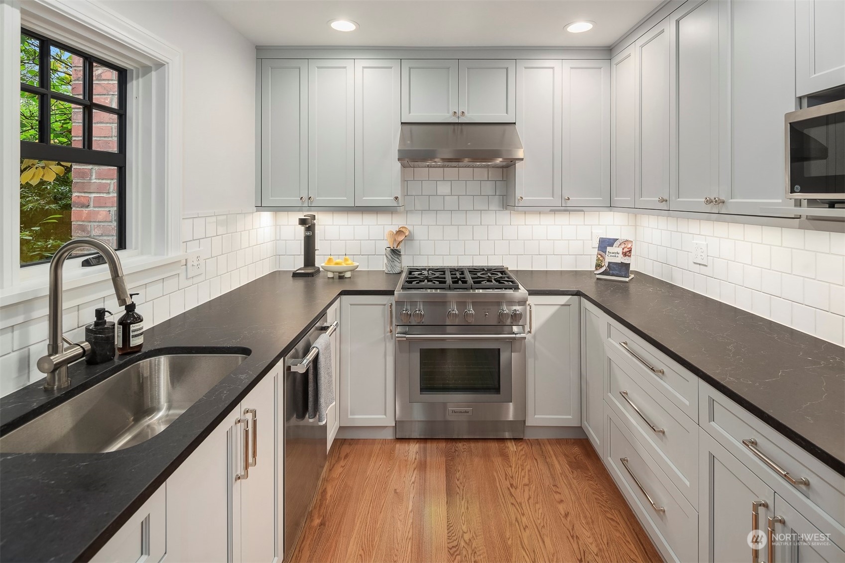 20 Armour Street Seattle, WA 98109 - Photo 10 of 34 a kitchen with a sink stove top oven and cabinets
