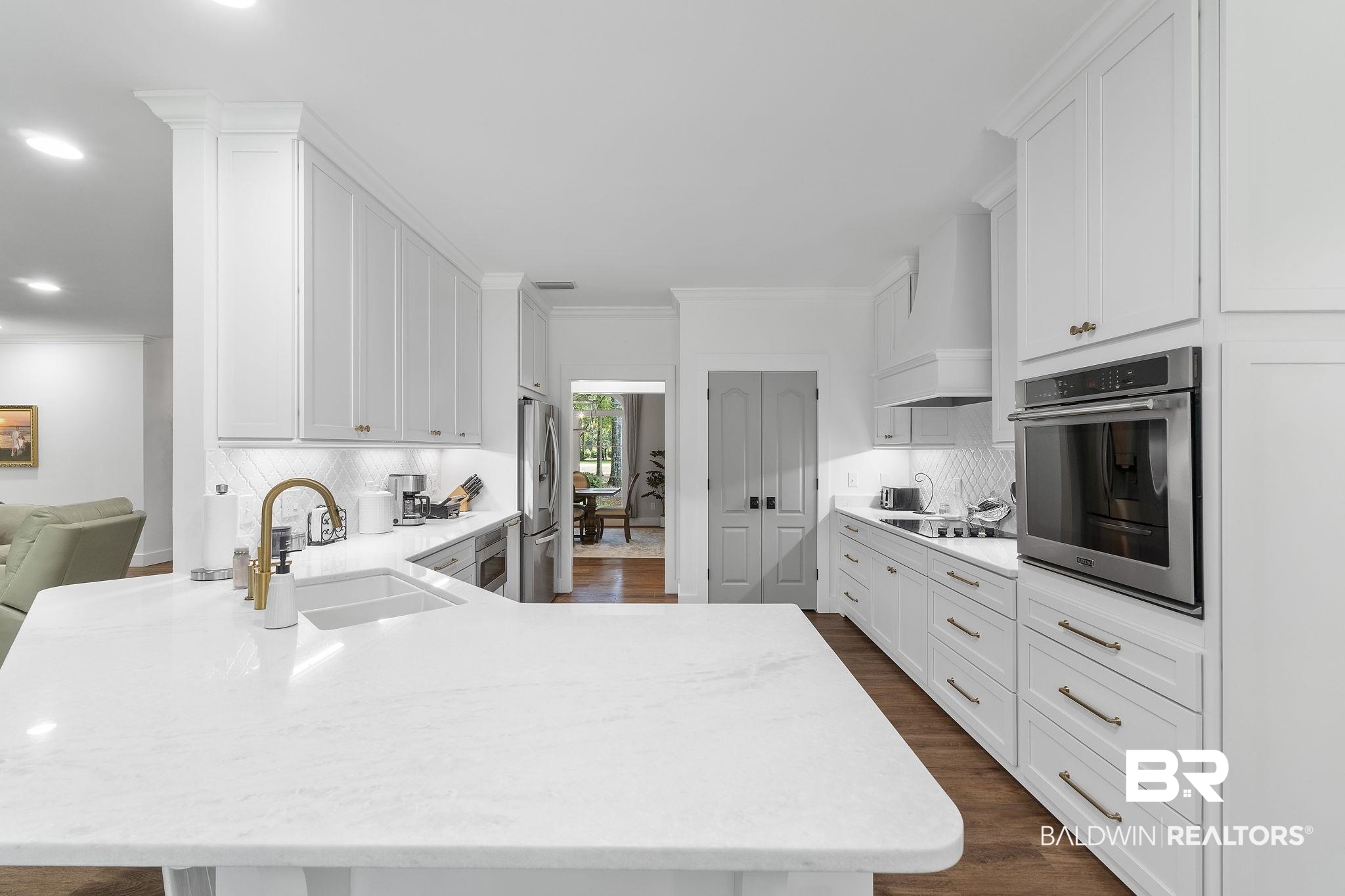 4451 Millhouse Road Gulf Shores, AL 36542 - Photo 23 of 50 Kitchen featuring stainless steel appliances, sink, decorative backsplash, dark hardwood / wood-style floors, and custom range hood