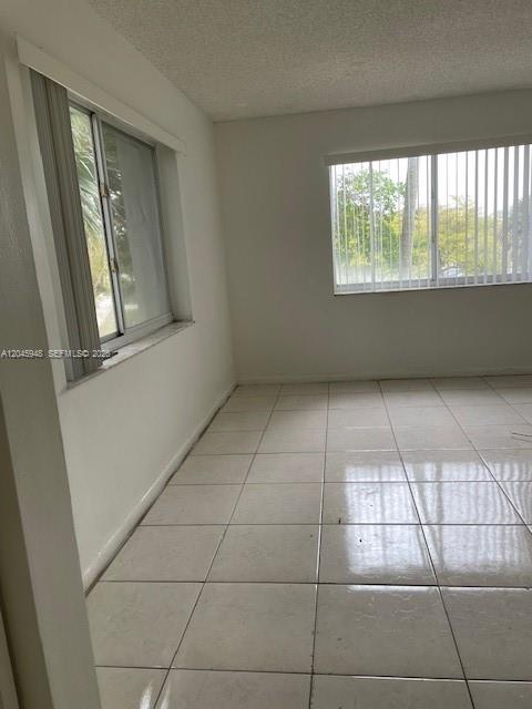 5612 Rock Island Road, Unit 167 Tamarac, FL 33319 - Photo 11 of 16 a view of an empty room with a window