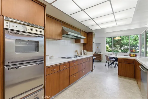 a kitchen with stainless steel appliances granite countertop sink stove and cabinets