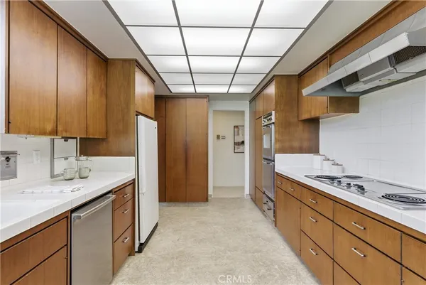 a kitchen with cabinets a sink and appliances