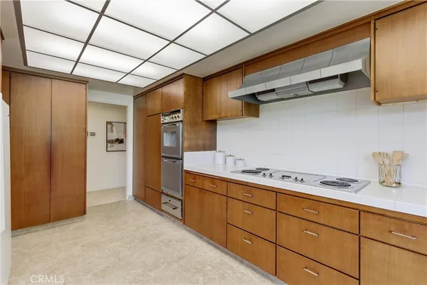 a dining area with a table chairs and a kitchen view