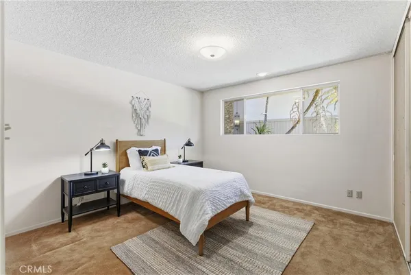 a bedroom with a bed and a night stand