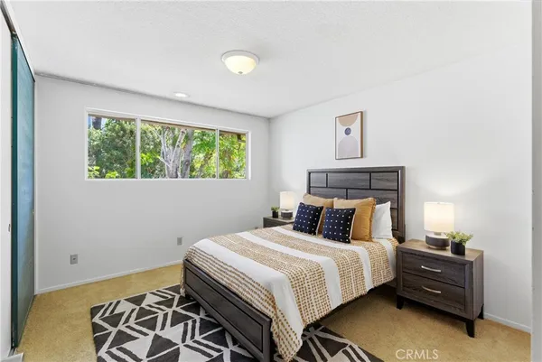 a bedroom with furniture and a large window