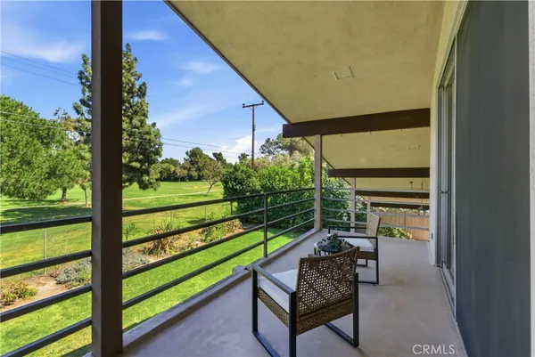 a view of a house with backyard porch and sitting area