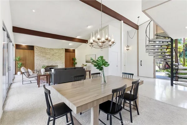 a view of a dining room with furniture and a potted plant