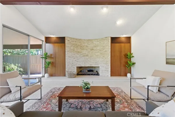 a living room with furniture a rug and a table